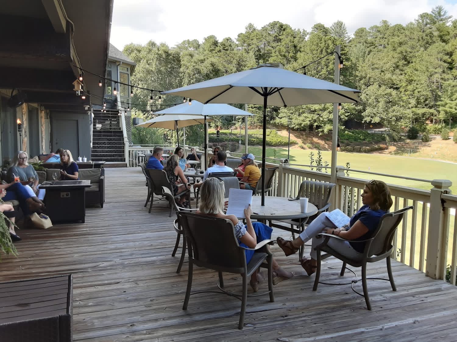 Guests relaxing on the Embers Vine patio overlooking the golf course